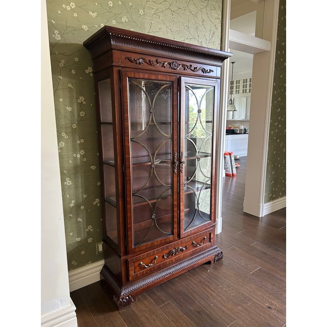 A beautifully crafted two-door display cabinet made from solid mahogany, showcasing rich wood grain and timeless design....