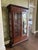 A beautifully crafted two-door display cabinet made from solid mahogany, showcasing rich wood grain and timeless design....