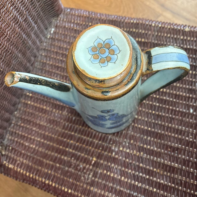 Ken Edwards Tonala Coffee Pot that has bluebirds, butterflies, and flowers. It is very pretty. This must have been made...