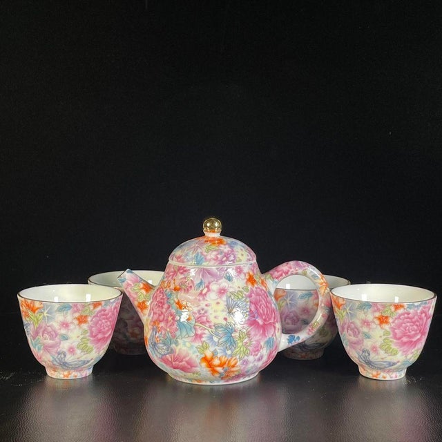 A beautiful Chinese Famille Rose porcelain tea set consisting of a teapot and a matching tea cup. Both pieces are...