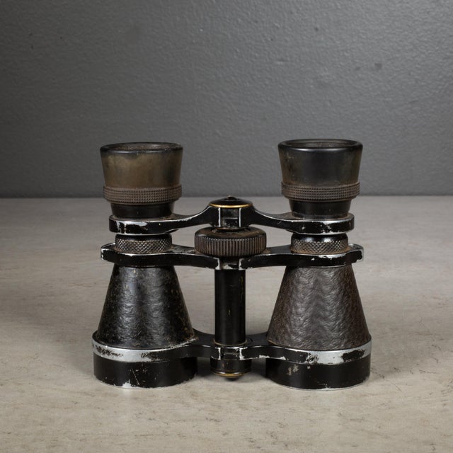 ABOUT World War l era leather wrapped and metal German military field binoculars. The objective lenses are 40 mm in...