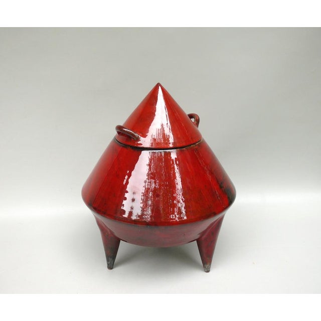 An unusual, large ceramic lidded box in a red glaze with black accents, made in the 70s. The lidded box is marked XII from...