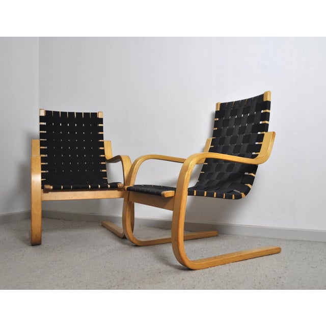 Cantilevered lounge chairs model 406 designed by Alvar Aalto for Artek. Bent laminated birch wood frames with woven canvas...