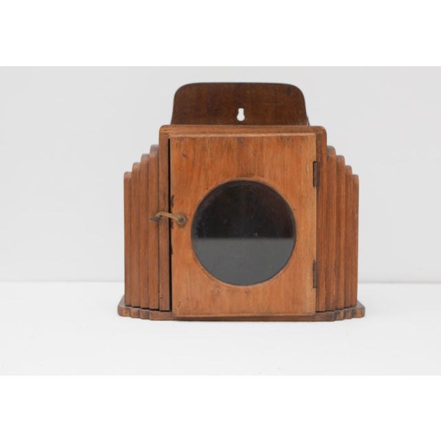 A charming Swedish Art Deco wall-mounted miniature curio cabinet, circa 1925, crafted in beautifully figured Chesnut...
