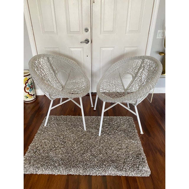 Very rare pair of highly unique, vintage mid century modern “clamshell” spaghetti rattan and steel chairs. These beauties...