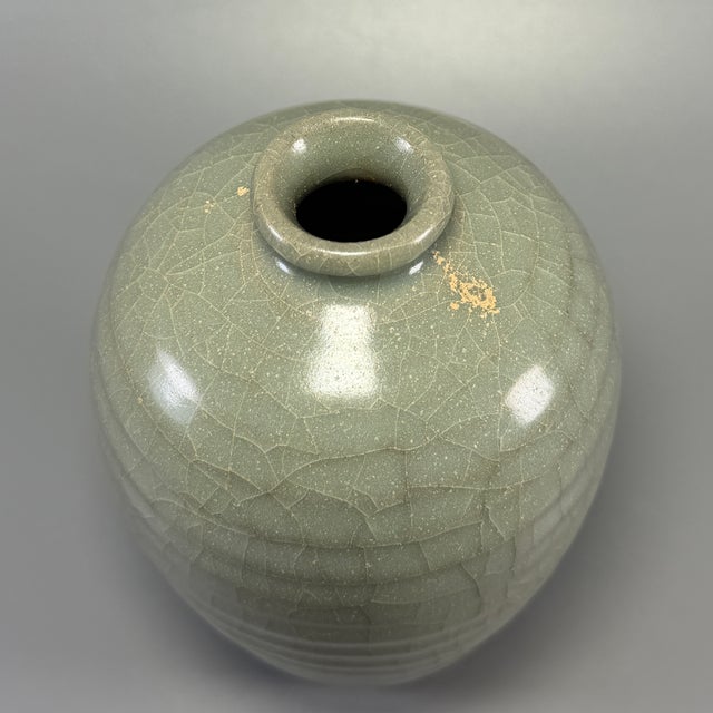 Fine antique Chinese celadon ribbed meiping vase. Classic tapered silhouette with raised horizontal ribbed decoration,...