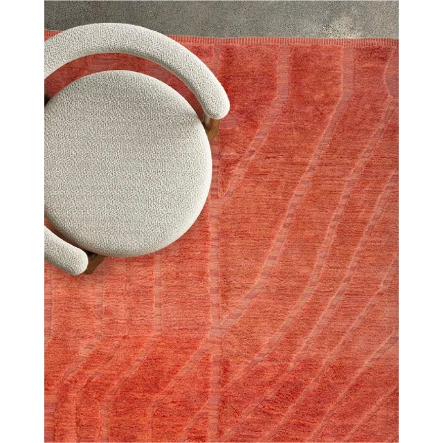 A warm, sunbaked field of burnt sienna, traced with fine, flowing lines that ripple across the surface like sand shaped by...