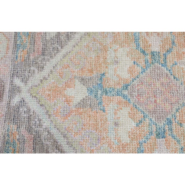 This modern Turkish Oushak rug is a stunning piece of art that has been handwoven using traditional techniques by skilled...