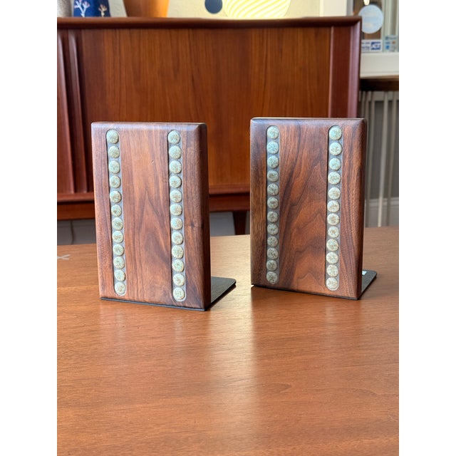 A beautiful matching pair of walnut block bookends with ceramic inlays designed by Gordon & Jane Martz for Marshall...