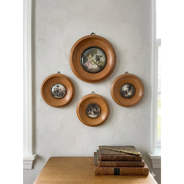 A charming vintage Spanish wall plaque featuring a finely detailed pastoral scene, set within a warm-toned wood frame and...