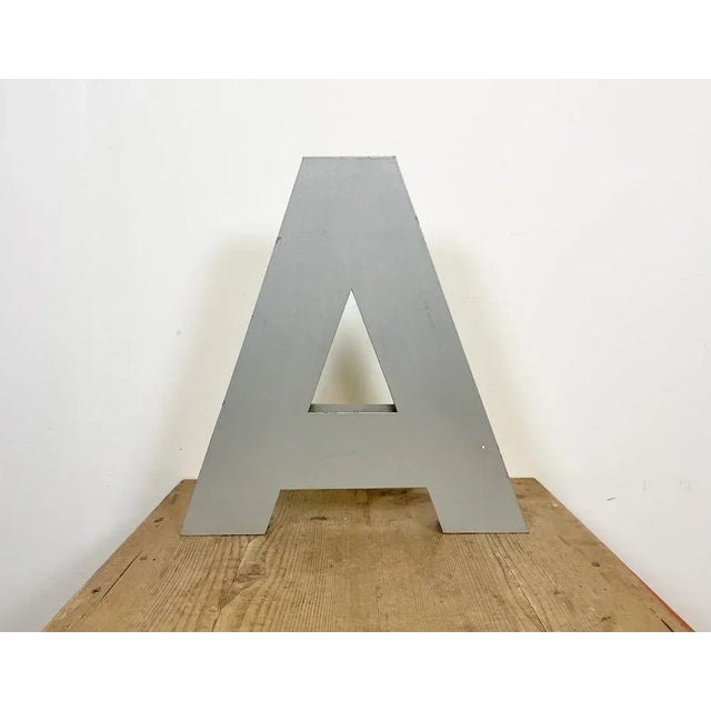 This vintage industrial facade letter “A” was made during the 1970s in Italy and comes from an old advertising banner. The...