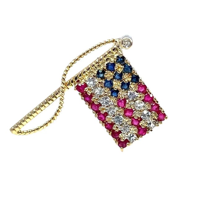 Enhance your collection with our striking flag brooch, meticulously crafted from 14k yellow gold. This modern piece...