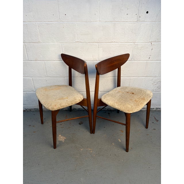 A stylish pair of 404-85 MCM dining chairs Attributed to Stanley. Crafted in warm walnut with comfortable upholstered...