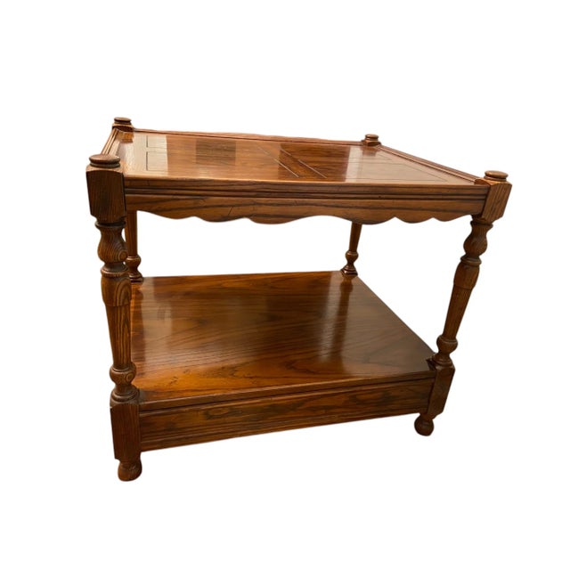 Quick Hits: - Henredon two-tiered side table - Rich wood finish with scalloped edge and intricate details - Features...