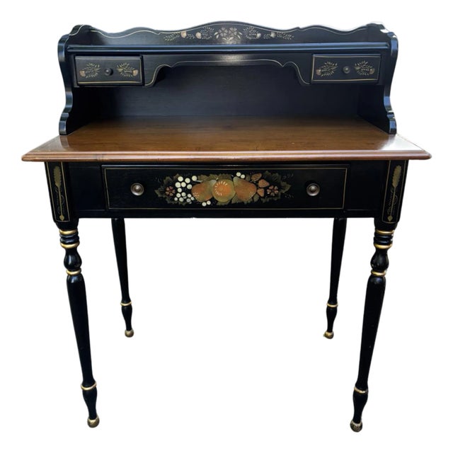 A stunning two-piece set featuring an Ethan Allen ebonized maple writing desk and matching rush-seat chair. This set is a...