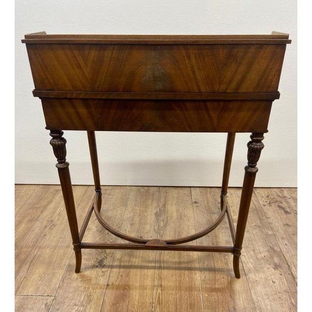 This is an elegant Regency-style writing table / bureau plat with superstructure, crafted in richly figured mahogany Also...