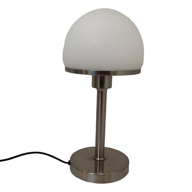 Bauhaus style table lamp with an opaline top. Attributed to Wagenfeld/Tecnolumen but as this piece has no markings we can...