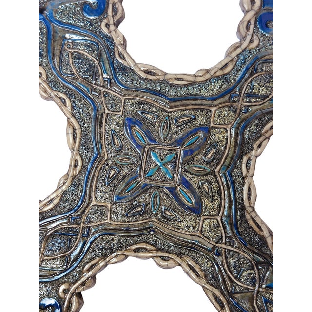 "Intertwining Flowers and Geometries" is a unique Raku ceramic work, entirely hand-molded and decorated by artist Stefania...