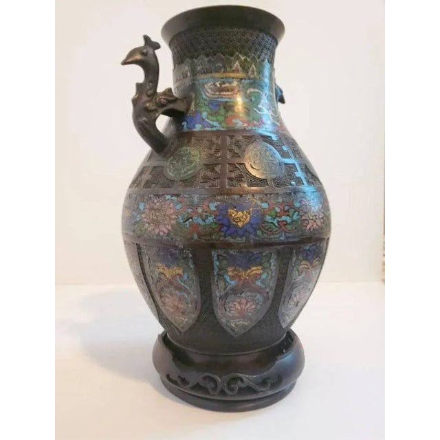 A finely detailed Japanese champlevé enameled bronze vase with Chinese design from the early 20th century. The embodiment...