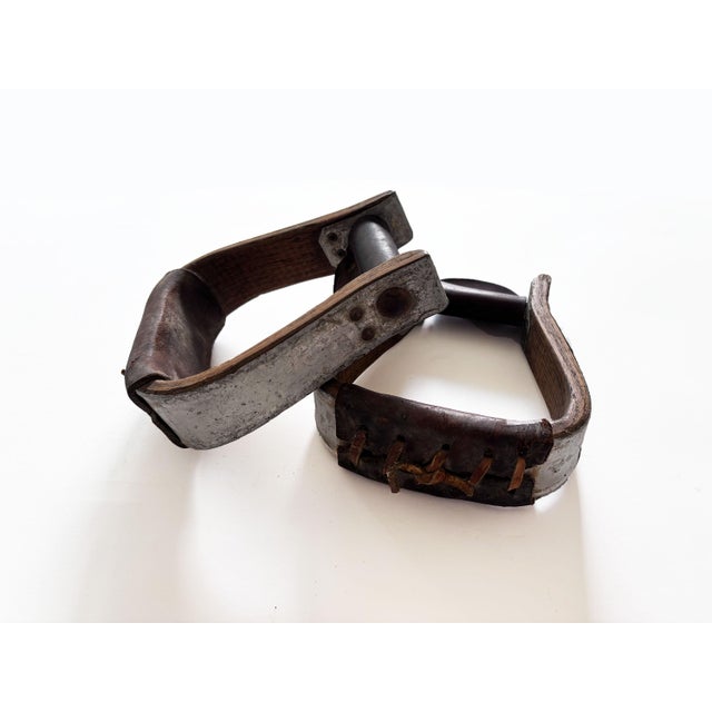 Add texture and warmth to your southwest or equestrian décor with this pair of vintage western horse saddle stirrups....