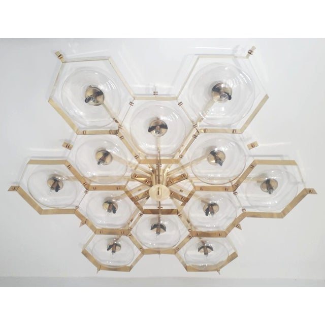 Italian midcentury flush mount with twelve clear Murano glass shades mounted on solid brass frame in lacquered polished...