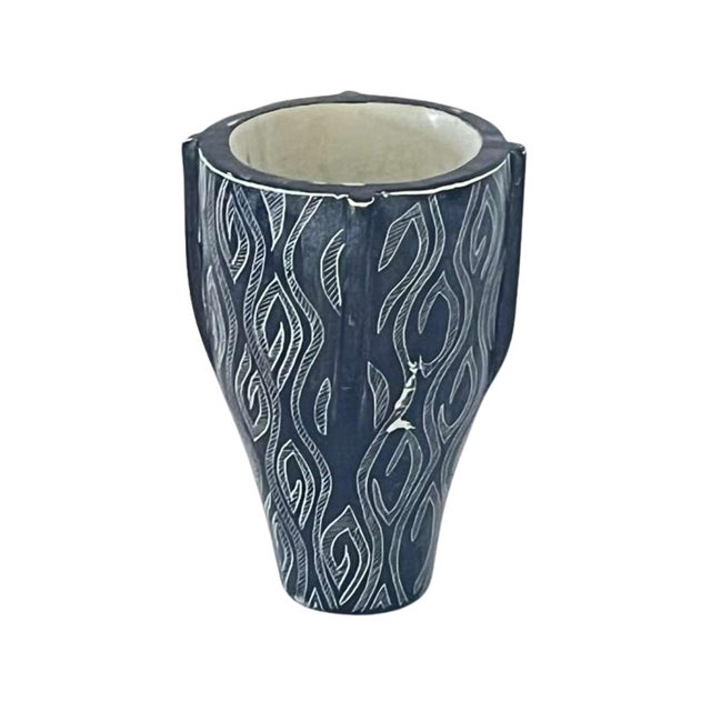 Immerse yourself in the rich culture and stunning beauty of Africa with this rare vase featuring indigenous designs....