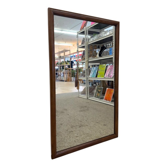 This vintage Mid-Century Modern rectangular wall mirror features a solid hardwood frame with mitered corner joinery and a...