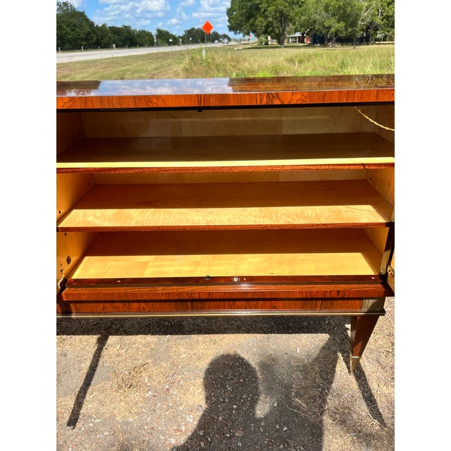 Striking French Art Deco sideboard from the 1930’s featuring richly figured Macassar ebony veneer, elegant geometric...