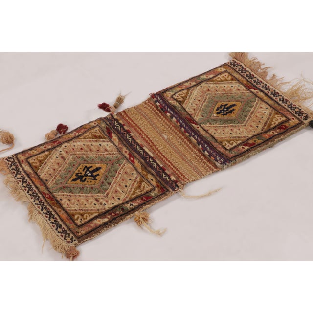 Hand-knotted in wool circa 1950-1960, this 1x3 gift-sized antique tribal textile originates from Pakistan and represents a...