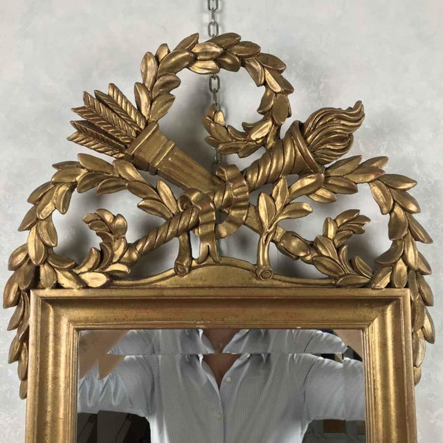 Carved Empire Style Gilded Mirror. Gilded mirror in carved wood with gilt leaf, exquisitely crafted, with a carved cornice...