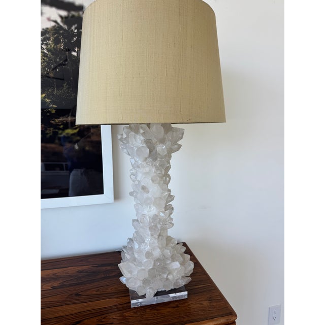 Stylish and very solid pair of table lamps composed of towering clear quartz/rock crystal. A square lucite base and drum...