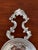 Elegant vintage silverplate tea strainer featuring a beautifully pierced bowl and ornate double scroll handles. The richly...
