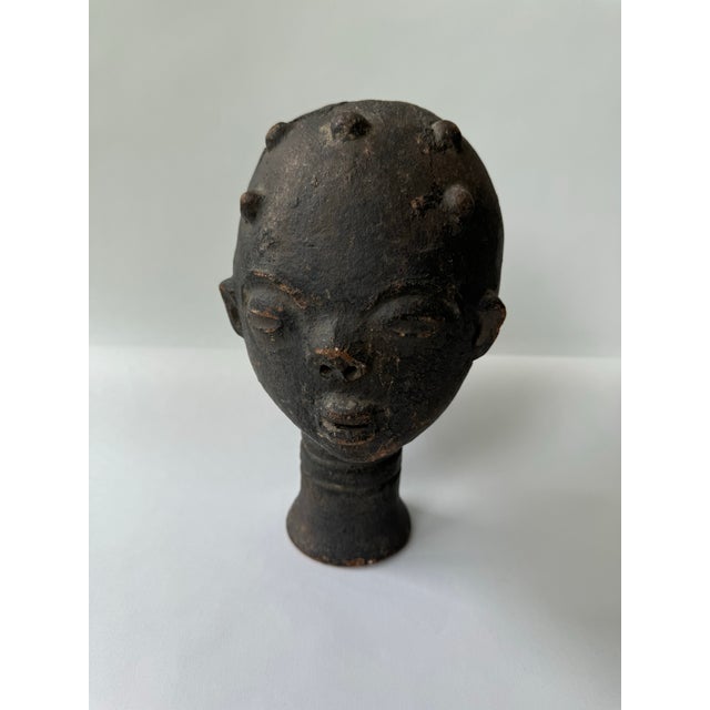Akan Terracotta Head Funerary Portrait Hand-formed and Burnished Terracotta This elegant terracotta head is a memorial...