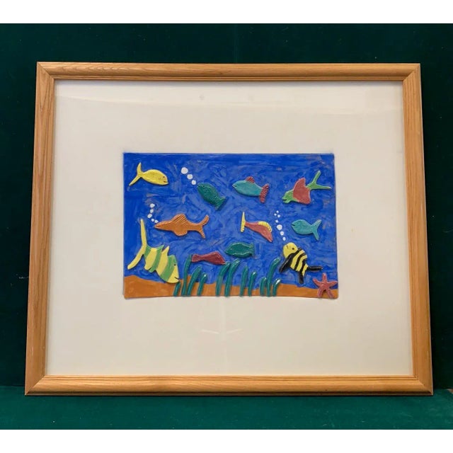 1970s artisan crafted ceramic fish wall art. The center ceramic tile measures 16" wide by 11" high and has a linen matte....