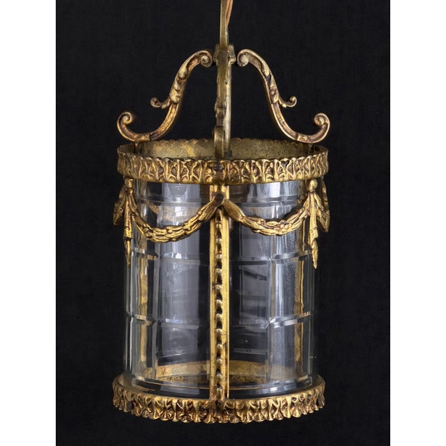 A striking and elegant antique french lantern pendant, featuring a cylindrical body enclosed with thick, faceted glass...