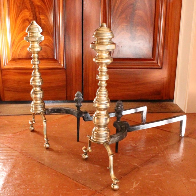 A good sized pair of American Brass Andirons consisting of turned elements terminating in substantial finials with an...