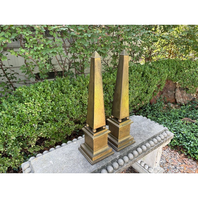 Pair Of Hollywood Regency Brass Obelisks. Offered is a tall pair of mid-century Neoclassical style brass obelisks (22...
