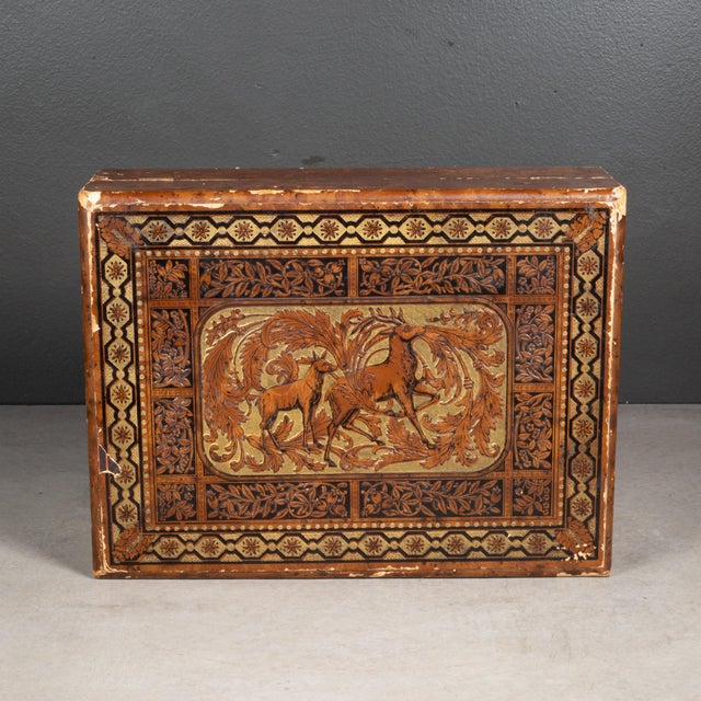 ABOUT A 19th century pressed paper lap desk with an embossed and gilded stag decoration to top. Top and bottom open to...