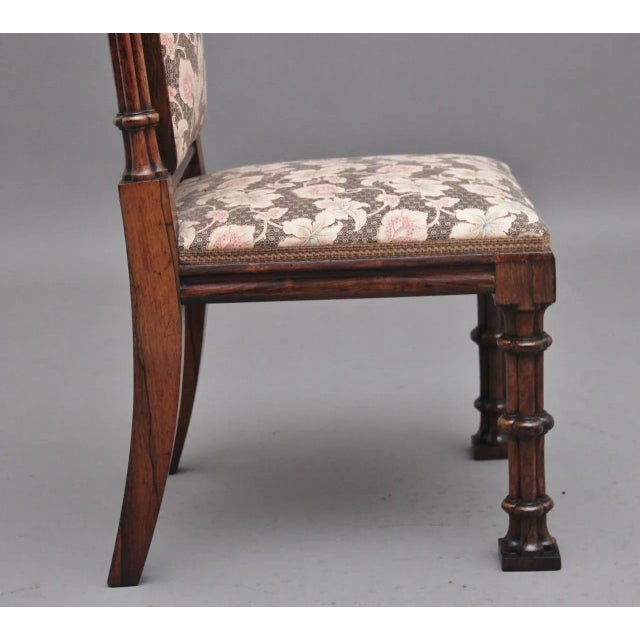 A lovely quality Regency rosewood side chair in the Gothic style, the padded high back upholstered in a decorative floral...