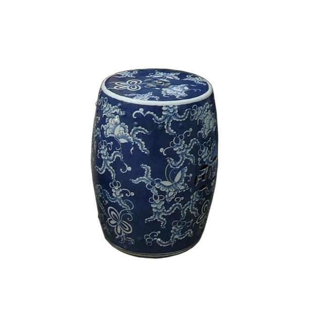 This is a hand-painted blue & white porcelain stool in a smooth surface dark blue base color with white flower butterflies...