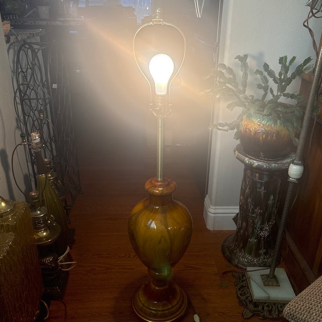 Large Mid Century Murano Glass Lamp with Gilt Wood Base. This lamp is a caramel color with brown swirls throughout it. It...