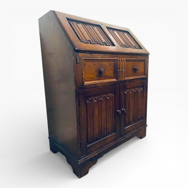 The vintage oak writing bureau is a classic secretary desk designed to provide a functional and elegant workspace with...