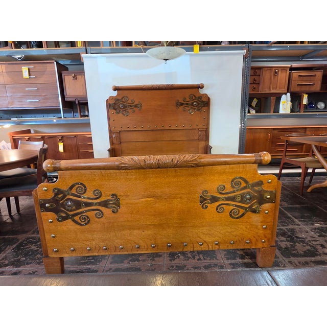 Antique 1880s Arts & Crafts Golden Oak Queen Bed. Wonderful Hand carving and custom metal work. This bed fits a queen...