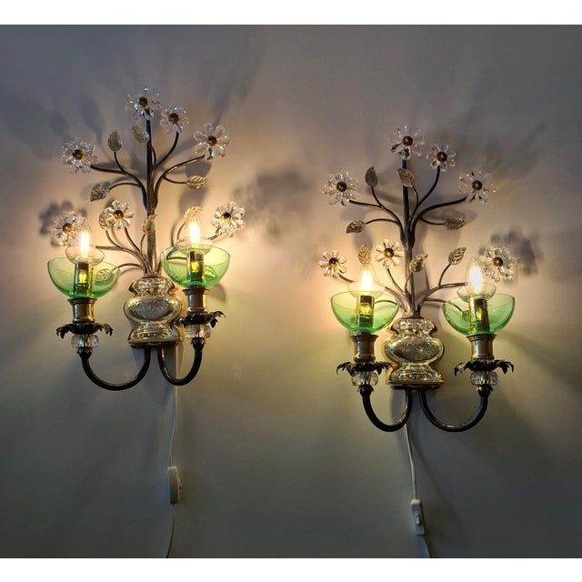 The wall lights are made of metal and mouth-blown Murano glass. The green glass elements for the candle holders are also...