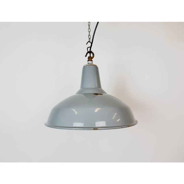 Industrial grey enamel factory pendant light made in United Kingdom during the 1960s. White enamel inside the shade. Iron...