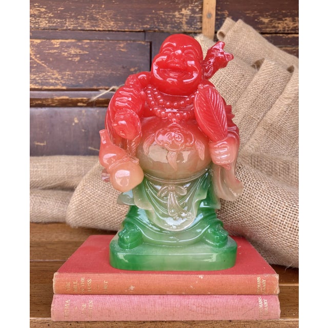 Lively smiling carved resin Buddha in the perfect holiday 2024 gradient colors.