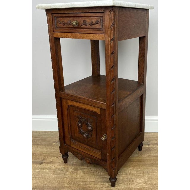 A charming Antique French single bedside table, beautifully crafted in oak and finished with an elegant marble top....