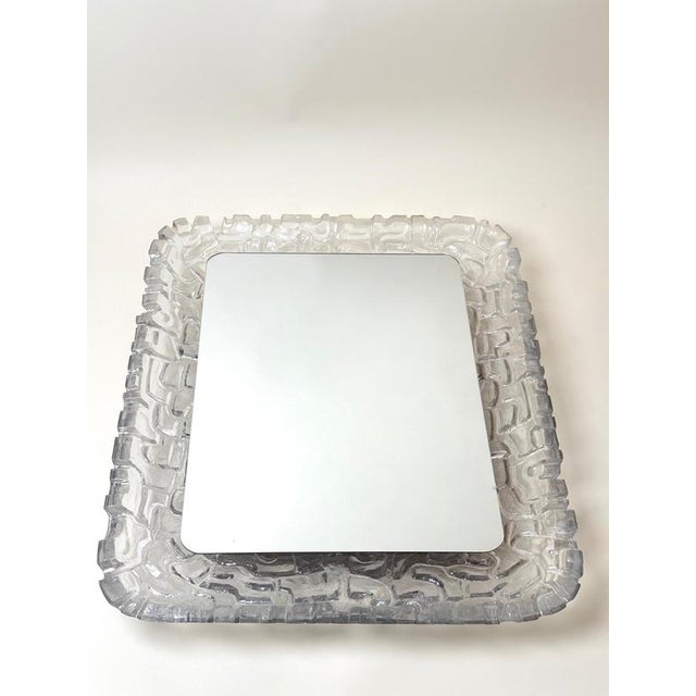 An exceptional illuminated wall mirror attributed to erco, manufactured in germany during the 1970s. This substantial and...