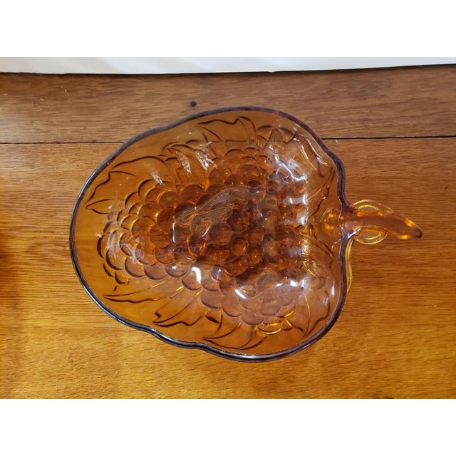 This is a Vintage Indiana Amber Glass Grape Bunch Embossed Serving Bowl. It measures 3 1/4" high, 13" long and 9 1/2" wide...