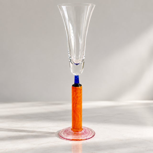 Sculptural late-20th-century hand-blown art glass champagne flute in a striking Postmodern / Memphis-inspired palette. The...